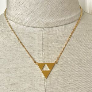 Trina Turk gold tone cut out triangle pendant necklace